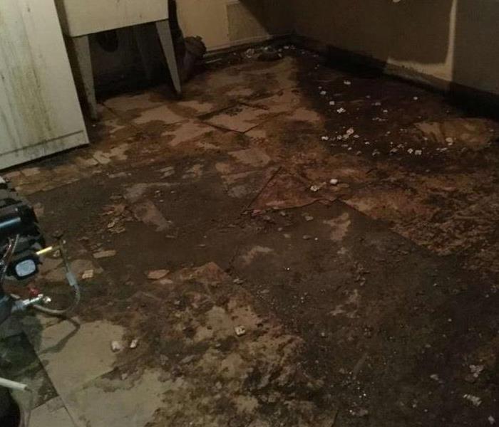 dirty flood water on floor of home due to heavy rains and storm damage
