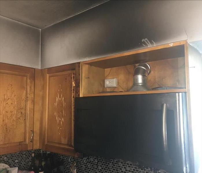Dark discoloration on wall in kitchen from smoke damage as a result of a kitchen fire.
