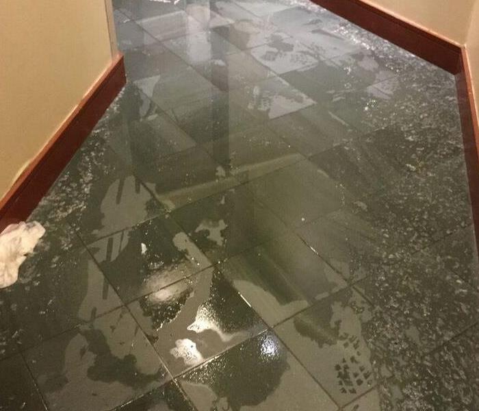 gray tile floor with water standing