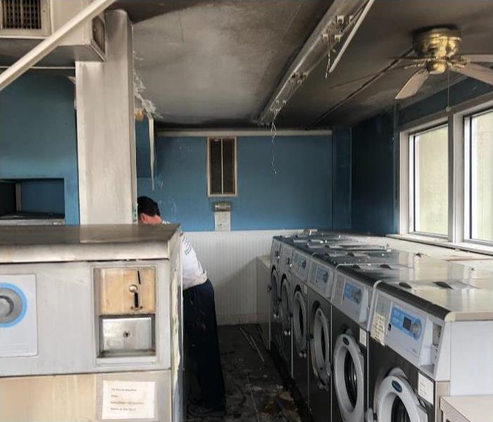 soot and smoke covering walls and floors after tv fire in laundromat